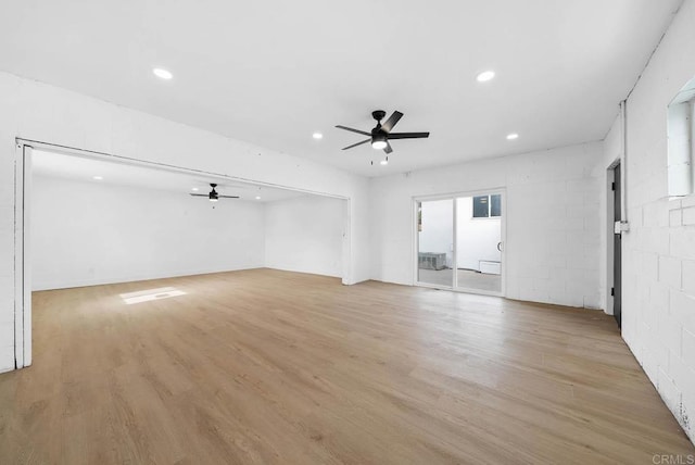 empty room with ceiling fan and light hardwood / wood-style floors