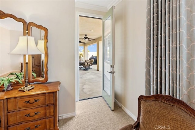 entryway featuring baseboards, ornamental molding, french doors, and light colored carpet