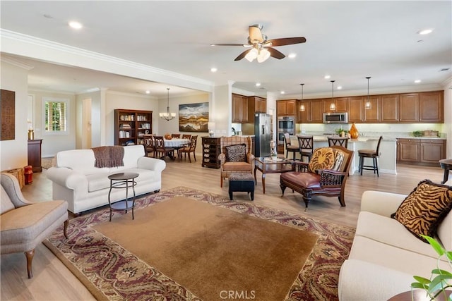 living area featuring light wood-style flooring, a ceiling fan, crown molding, and recessed lighting