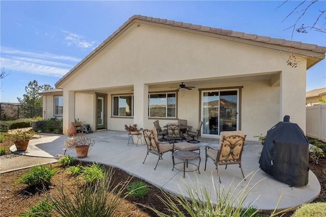 back of property with a patio, fence, a ceiling fan, and stucco siding