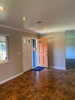 foyer featuring crown molding and dark parquet floors