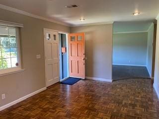 foyer entrance featuring ornamental molding and dark parquet flooring