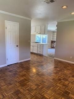 unfurnished room with dark parquet flooring and crown molding