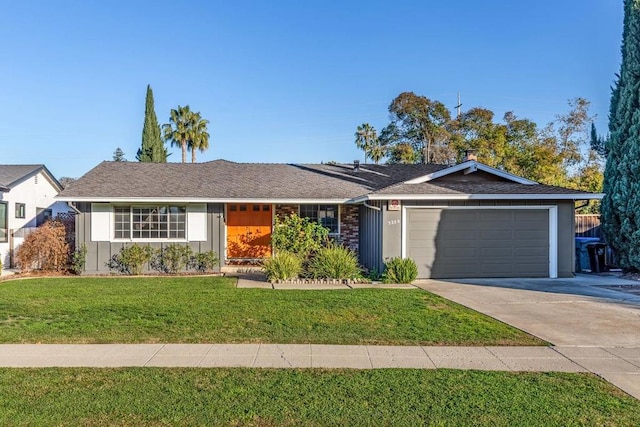 ranch-style house featuring a garage and a front lawn