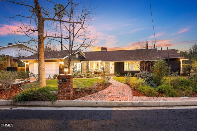 ranch-style house featuring a garage