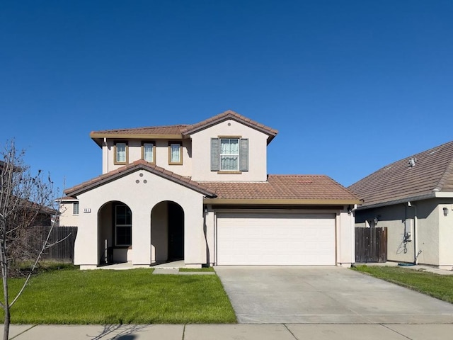 mediterranean / spanish home featuring a garage and a front yard