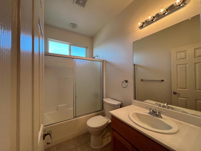 full bathroom with enclosed tub / shower combo, tile patterned floors, toilet, and vanity