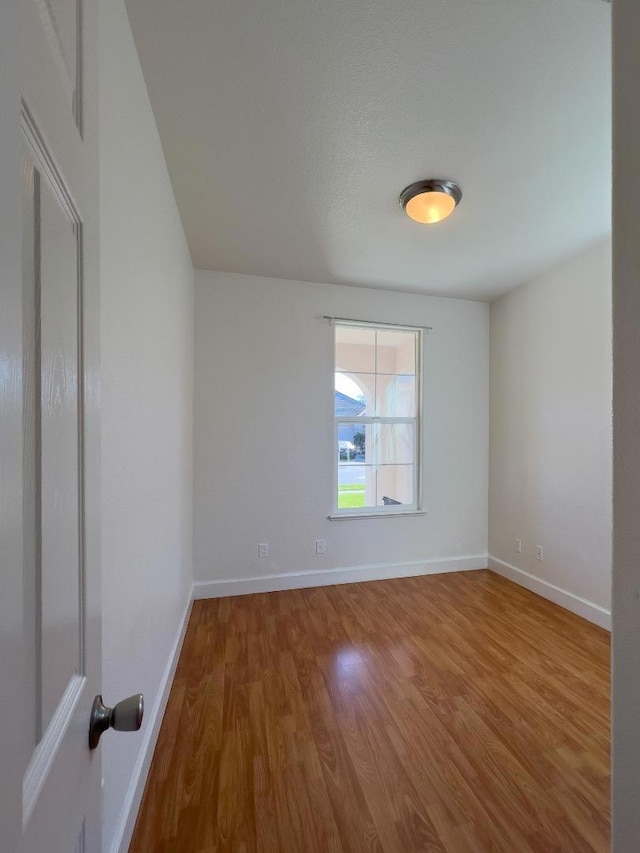 spare room featuring hardwood / wood-style flooring