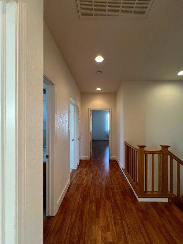 hallway featuring dark hardwood / wood-style flooring