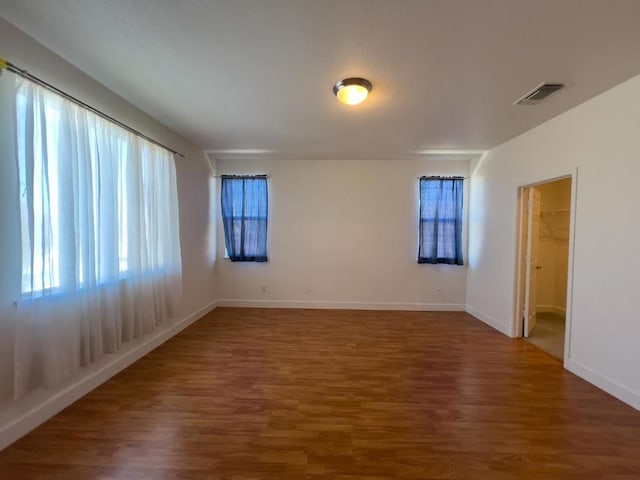 spare room with dark wood-type flooring