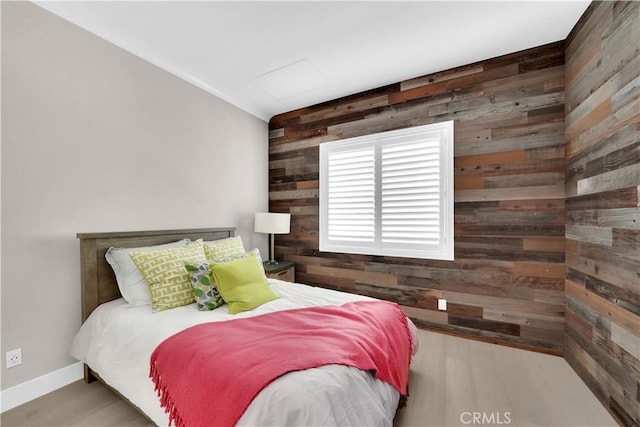 249 Chorus, Irvine, CA 92618 - bedroom with wood finished floors, wood walls, baseboards, and an accent wall