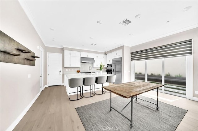 249 Chorus, Irvine, CA 92618 - dining space featuring ornamental molding, baseboards, light wood-style flooring, and visible vents