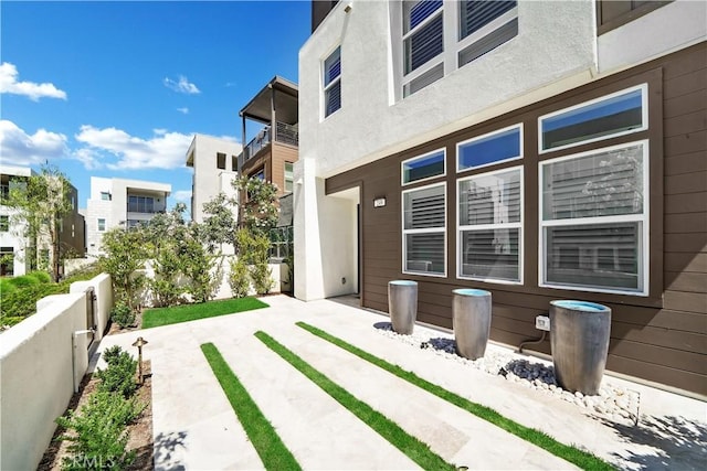 249 Chorus, Irvine, CA 92618 - view of property exterior featuring a balcony, a patio area, and fence