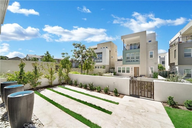 249 Chorus, Irvine, CA 92618 - view of patio featuring a fenced front yard, a gate, and a residential view