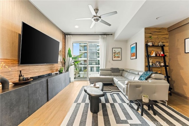 living room featuring light hardwood / wood-style floors and ceiling fan