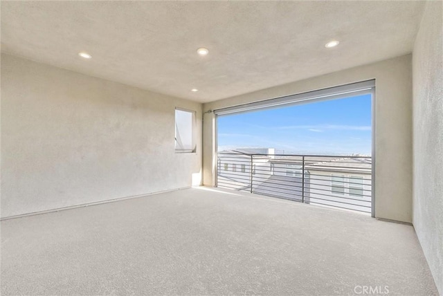 empty room with recessed lighting and carpet