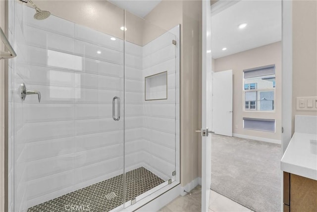 full bathroom featuring a shower stall, vanity, and baseboards