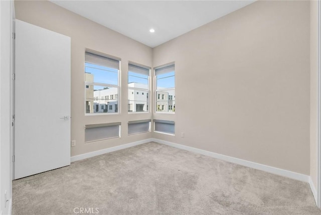 unfurnished room with recessed lighting, carpet, and baseboards