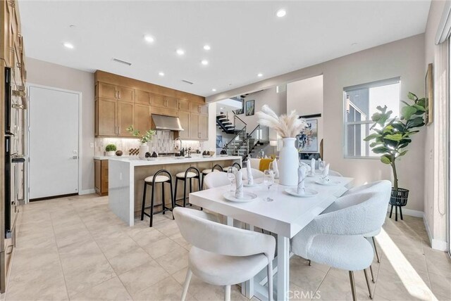 dining room with stairs, baseboards, visible vents, and recessed lighting