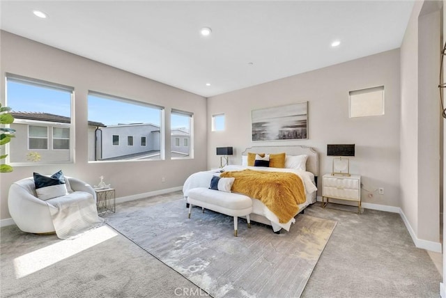 bedroom featuring light carpet, recessed lighting, and baseboards