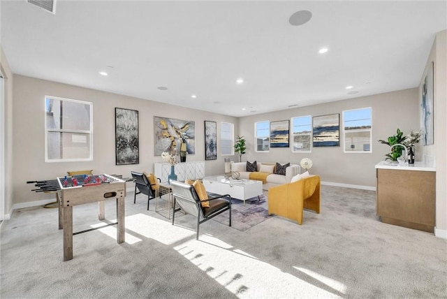 living area featuring recessed lighting, light carpet, visible vents, and baseboards