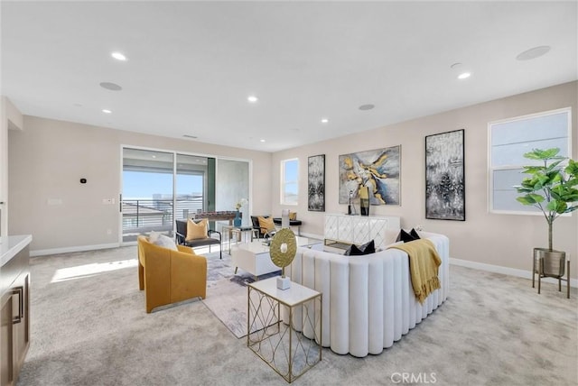 living room with recessed lighting, light carpet, and baseboards