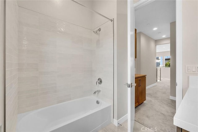 bathroom featuring recessed lighting, vanity, baseboards, and bathing tub / shower combination