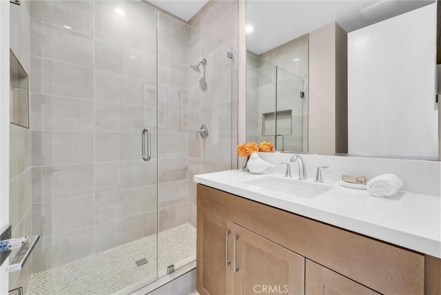 bathroom featuring a stall shower and vanity