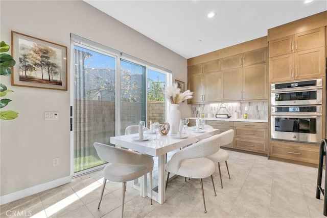 dining space featuring recessed lighting, light tile patterned flooring, and baseboards