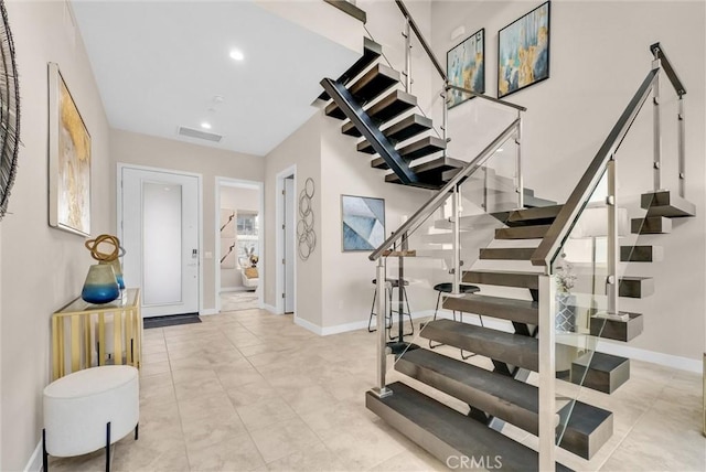 entrance foyer featuring visible vents, stairway, baseboards, and recessed lighting