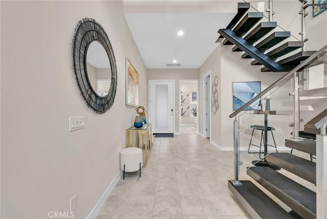 interior space featuring recessed lighting, visible vents, stairway, and baseboards