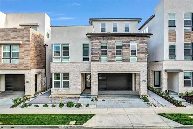 view of front facade with a garage, concrete driveway, and stucco siding