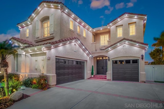 mediterranean / spanish-style home featuring a balcony and a garage