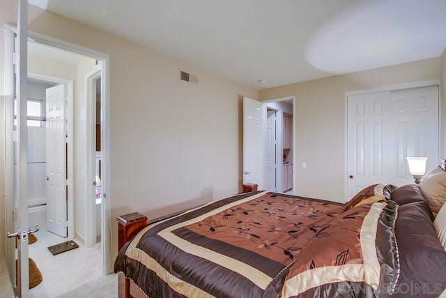 bedroom featuring light carpet and a closet