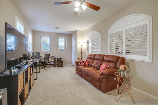 living room featuring light colored carpet and ceiling fan