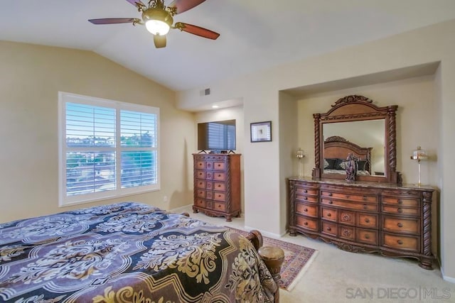 bedroom with ceiling fan, lofted ceiling, and light carpet