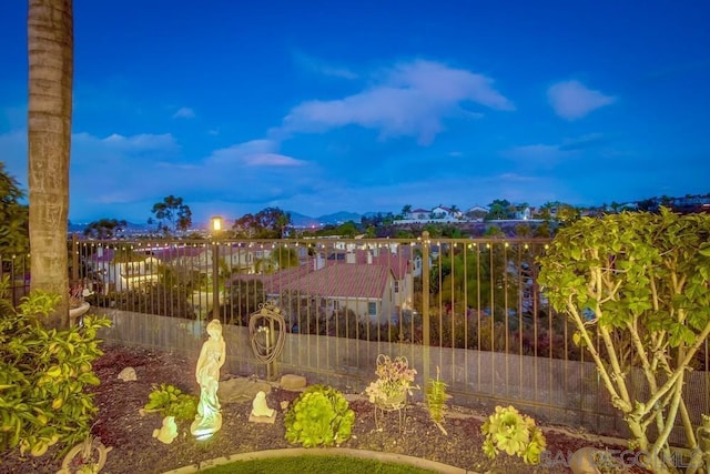 yard at dusk featuring a mountain view