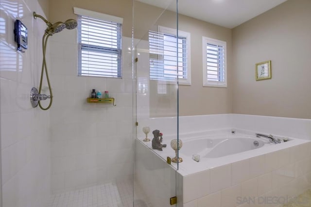 bathroom featuring shower with separate bathtub