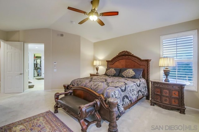 bedroom featuring lofted ceiling, light colored carpet, and ceiling fan