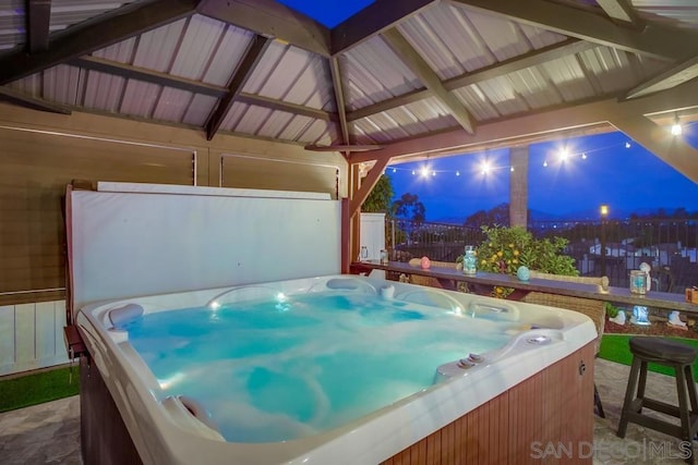 exterior space with a hot tub and a gazebo