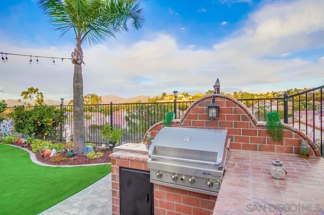 view of patio / terrace featuring area for grilling and a grill