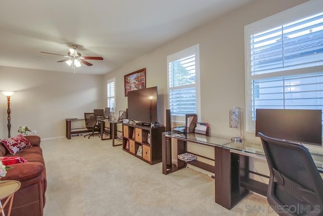 office with light carpet and ceiling fan