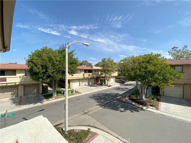 view of road featuring curbs, street lighting, and sidewalks