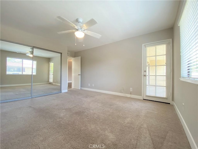 unfurnished bedroom featuring carpet floors, ceiling fan, and baseboards