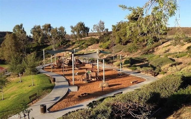 exterior space featuring playground community and a yard