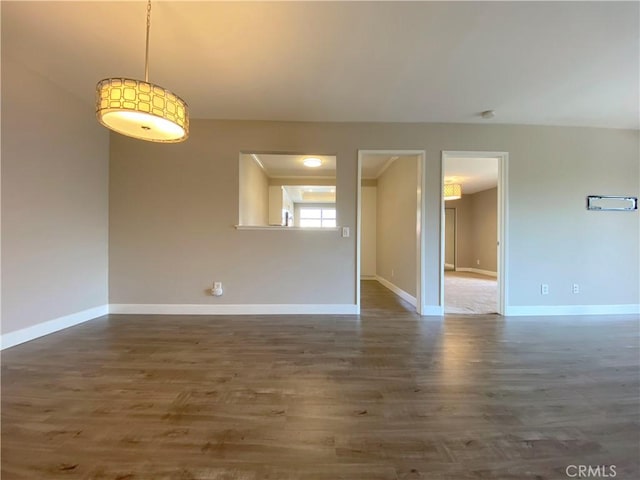 empty room with wood finished floors and baseboards