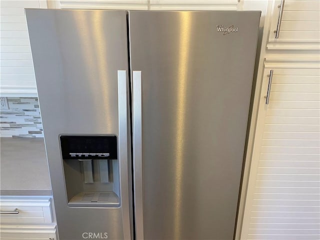 interior details featuring white cabinetry and stainless steel fridge with ice dispenser