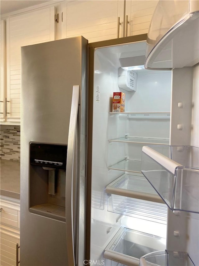 kitchen featuring stainless steel refrigerator with ice dispenser and decorative backsplash