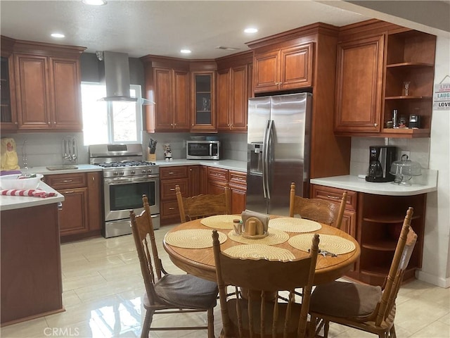 kitchen with decorative backsplash, stainless steel appliances, and wall chimney exhaust hood