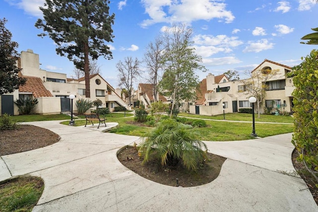 view of home's community with a yard